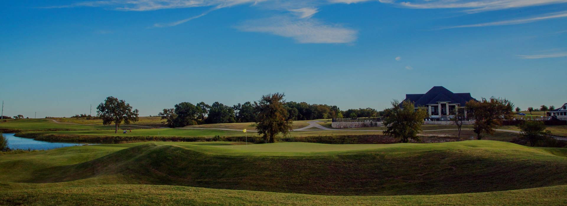 View of golf course with houses in background