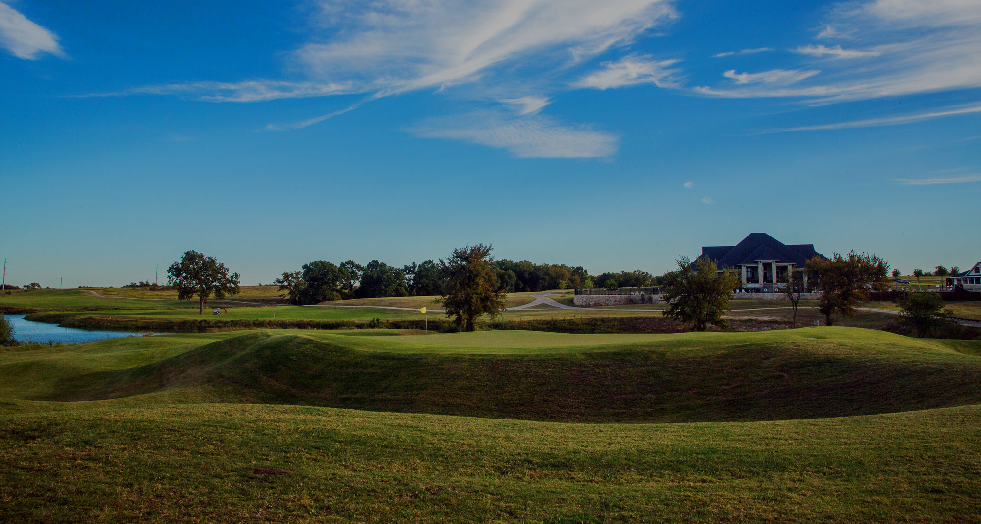 View of golf course with houses in background